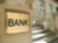 Entrance to a bank, focus on brass 'bank' sign