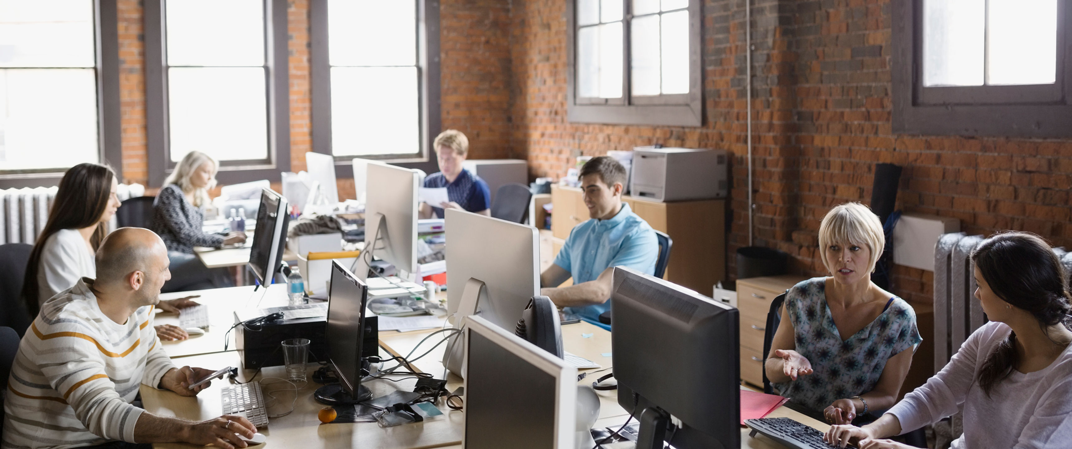 Business people working at computer workstations in office