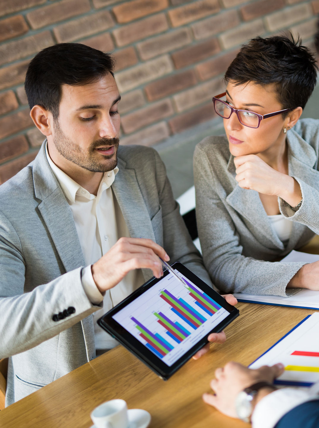 Business people discussing market research statistics during business meeting