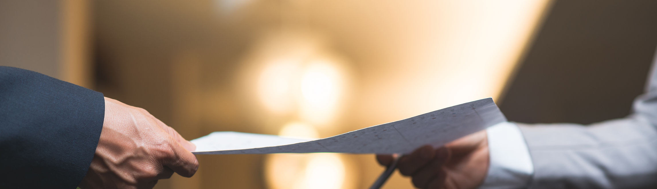 Hands of business people passing important document