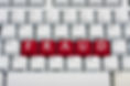 A computer keyboard with red keys spelling the word 'fraud'